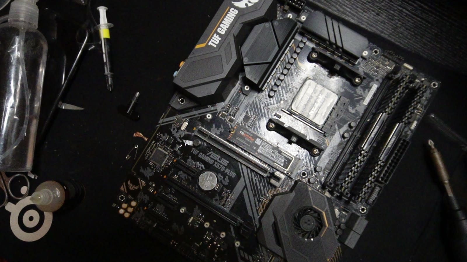 The ASUS TUF Gaming X570-Plus silkscreen label visible on the cleaned motherboard after rework.